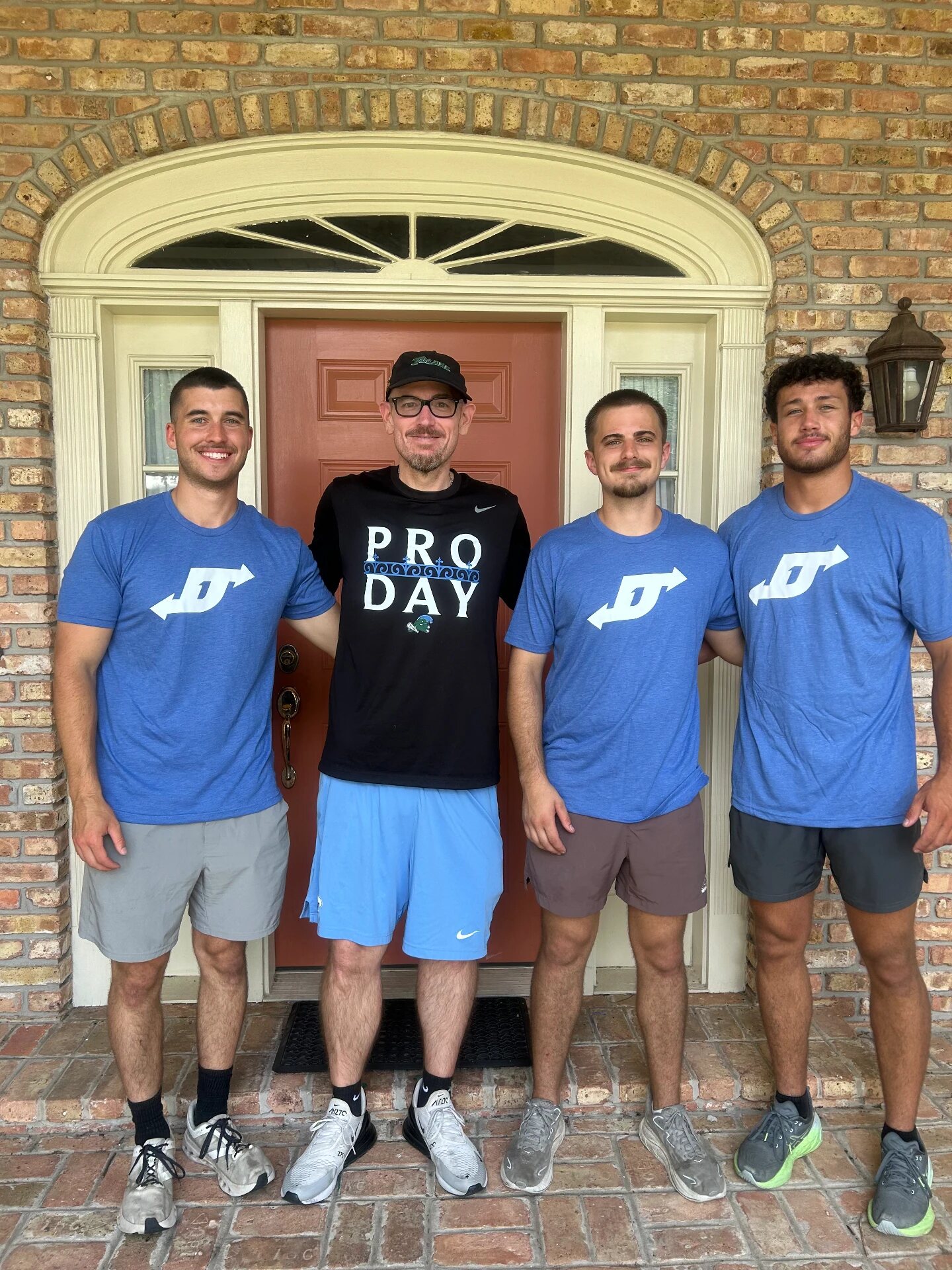 A family standing in the doorway of their new home