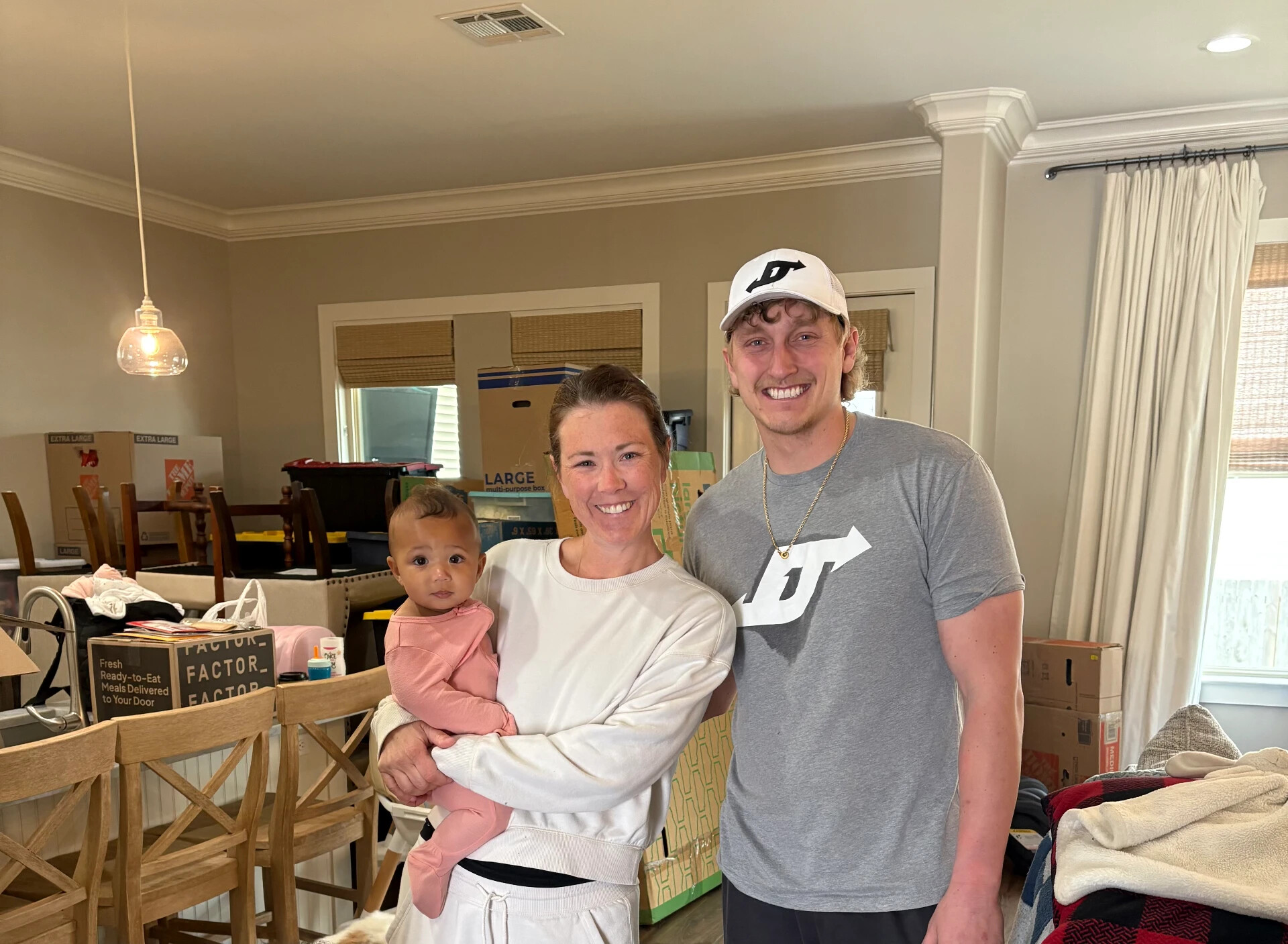 A family with their baby in their new home after a move